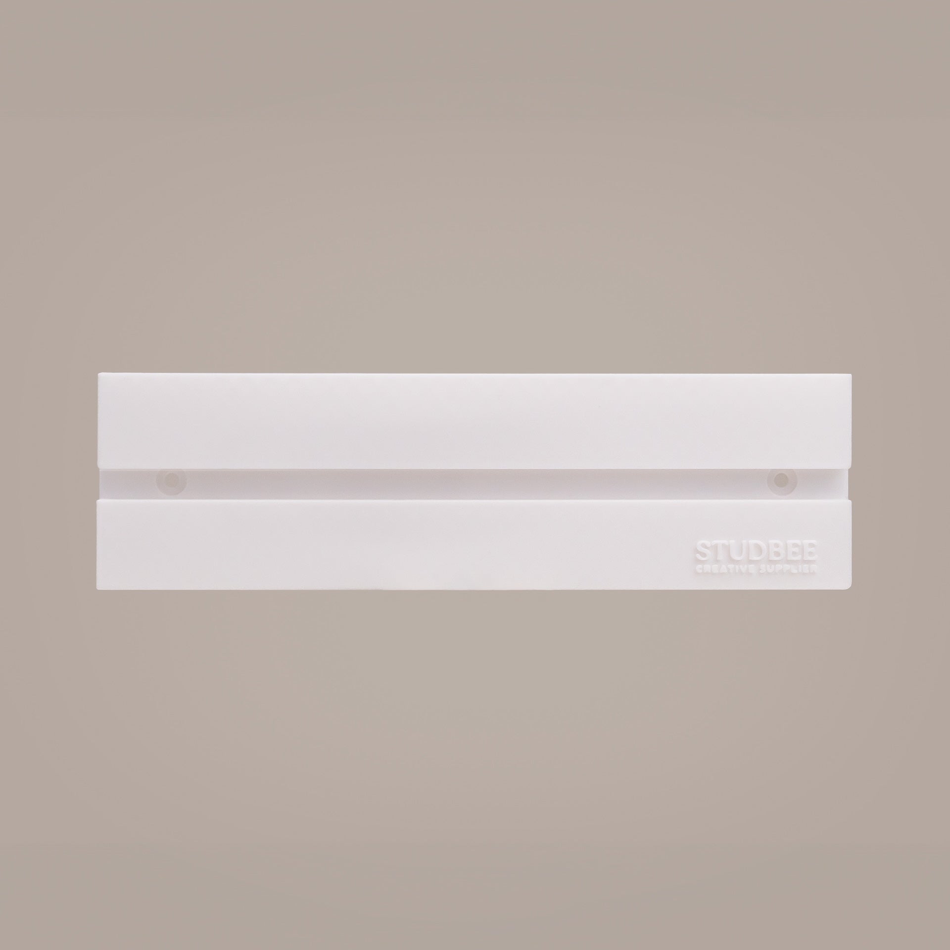 A single-tier white display shelf with the "STUDBEE" logo, designed to hold LEGO mini-figures or collectibles.